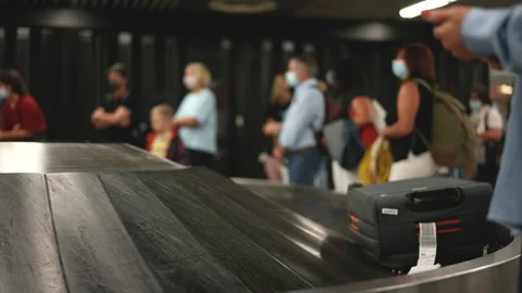 People wait baggage after arrival at airport. Suitcases moving conveyor belt. Stock Footage 276876195