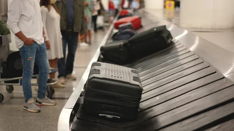 People wait baggage after arrival at airport. Suitcases moving conveyor belt. Stock Footage 276918195