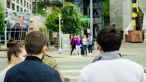 People wait at cross walk in downtown Seattle Stock Footage 73498240