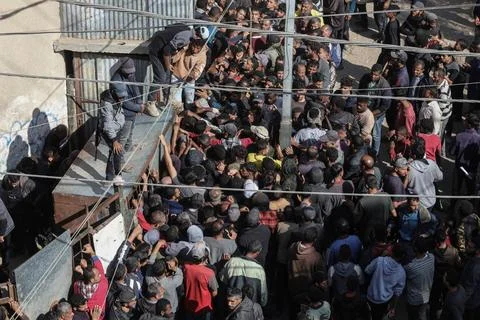  People wait in crowded lines for hours to buy bread at a bakery operating... Stock Photos