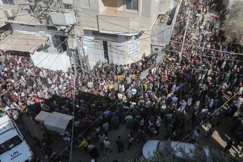  People wait in crowded lines for hours to buy bread at a bakery operating... Stock Photos