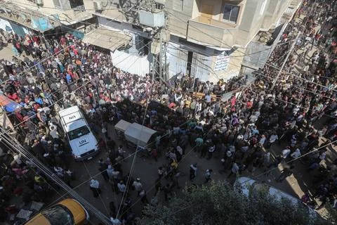  People wait in crowded lines for hours to buy bread at a bakery operating... Stock Photos