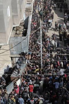  People wait in crowded lines for hours to buy bread at a bakery operating... Stock Photos