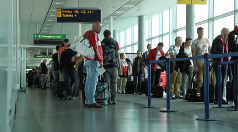 People wait at gate to board plane Stock Footage