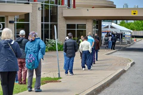People wait in line for a Covid-19 test in Scarborough, Ontario. Stock Photos