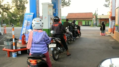 People wait in line to fill up their tanks at a petrol station Stock Footage 279865858