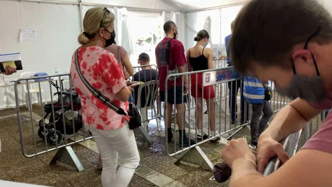 People wait in line inside tent for Covid-19 testing &amp; vaccines, Tel-Aviv Israel Stock Footage 165773007
