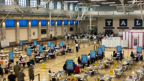 People wait in line inside a Yale COVID-19 Vaccine Clinic Station 2021 스톡 동영상 152182356