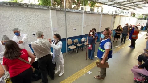 People wait in line for Pfizer BioNTech Coronavirus vaccine in Brazil, 4K Stock Footage 153634962