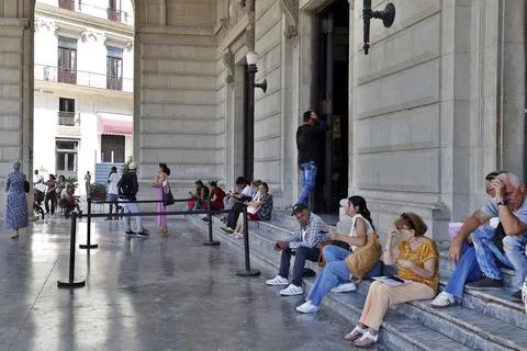 People wait outside the Spanish Consulate in Havana amid uncertanty over, Cuba - Stock Photos