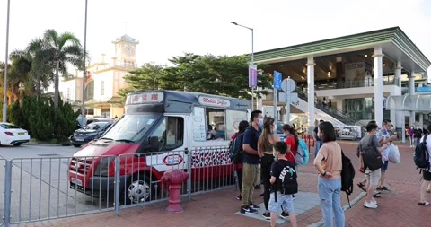 People wait in queue to buy ice cream from an ice cream truck in Central, Hon Stock Footage 159404026