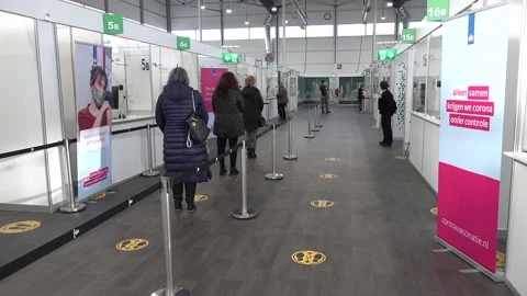 People wait in queue inside vaccination center in Rotterdam Netherlands Stock Footage 147075170