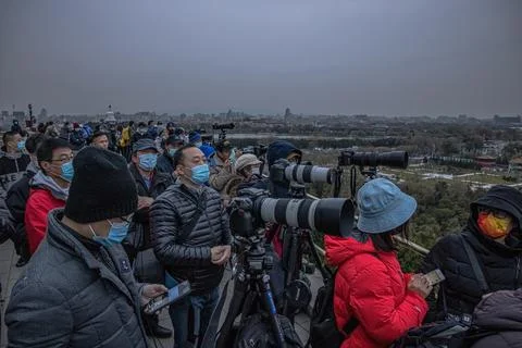 People wait to see the partial lunar eclipse in Beijing, China - 19 Nov 2021 Stock Photos