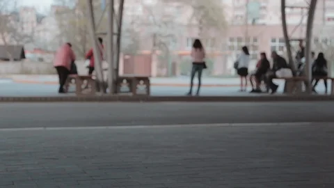 People wait for transport at a stop Stock Footage 106984993