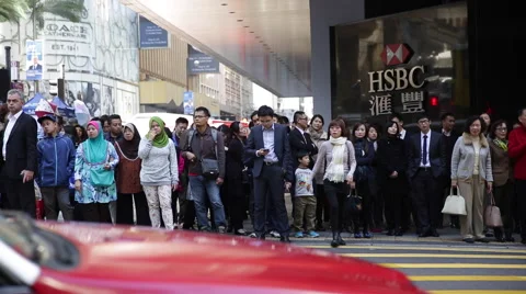 People wait to walk through a crossing in downtown Hong Kong Stock Footage 45409491