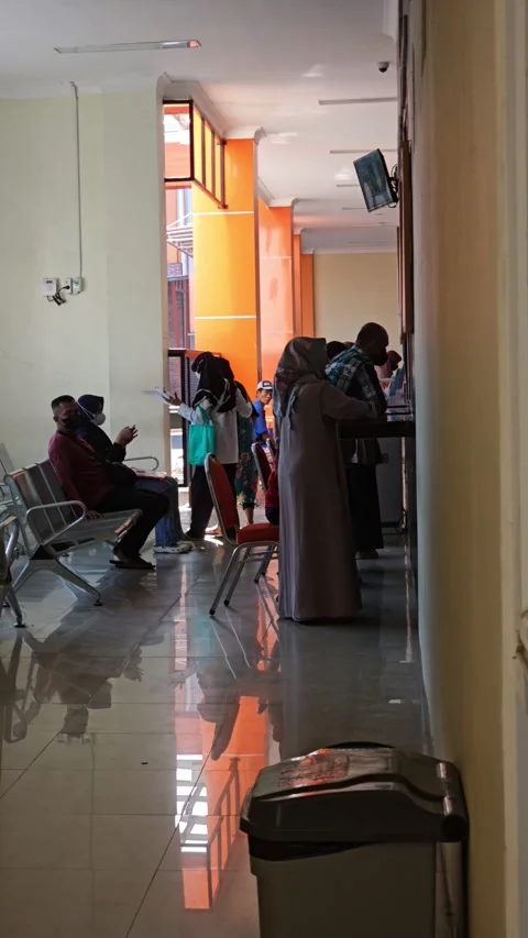 People Waiting And Queuing At A Clinic Registration Counter Stock Footage 340013636