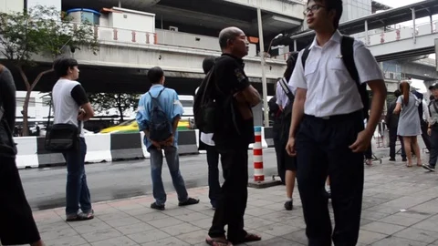 People waiting for a bus on the bus stop . Stock Footage 71590842