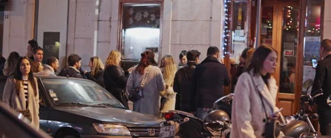 People waiting in line to enter a bar Stock Footage 151359268