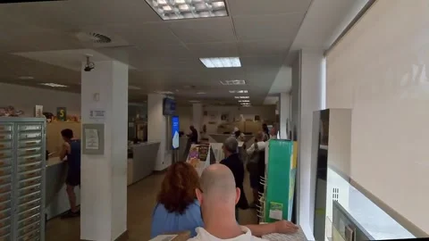 People Waiting in Line Inside a Post Office 스톡 동영상 345926604
