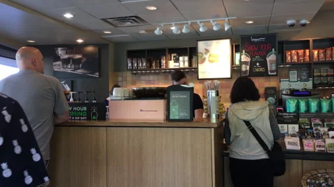 People Waiting in Line at a Modern Coffee Shop Counter Stock Footage 343829657