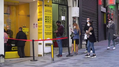 People waiting in a masked bank queue in Taksim and İstiklal Street in Corona Stock Footage 148475133
