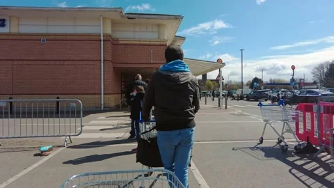 People waiting in the queue to enter the Tesco Extra Superstore Stock Footage 153289089