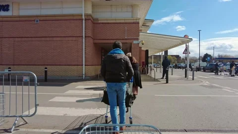 People waiting in the queue to enter the Tesco Extra Superstore Stock Footage 153289096