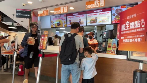 People Waiting in Queue to Order Food at a Busy Fast Food Restaurant Counter Stock Footage 340064940