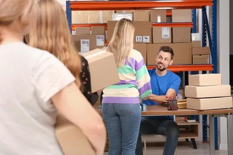 People waiting in queue at post office Stock Photos