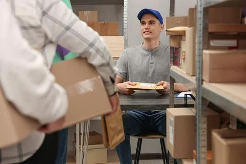 People waiting in queue at post office indoors Stock Photos