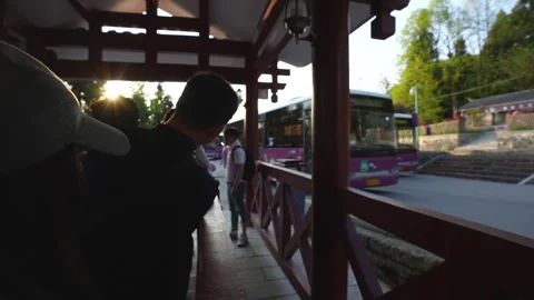 People waiting at shuttle bus stop in Zhangjiajie, China Stock Footage 341658584