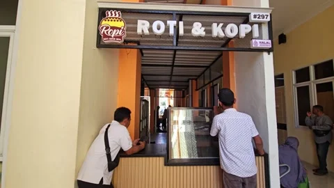 People Waiting At A Small Bread And Coffee Stall In A Corridor Stock Footage 340013575