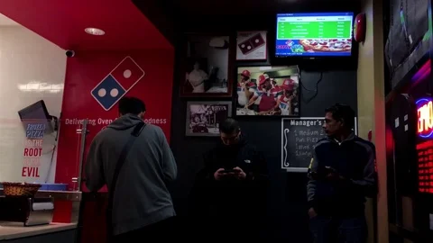 People waiting for their ordering inside Domino pizza Video stock 70531563