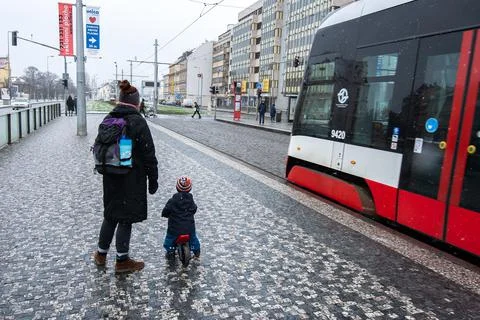 People waiting walking the platform while waiting descending for tram on a sn Stock Photos