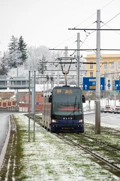 People waiting walking the platform while waiting descending for tram on a sn Stock Photos