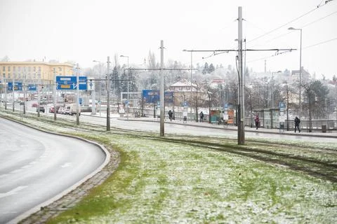 People waiting walking the platform while waiting descending for tram on a sn Stock Photos