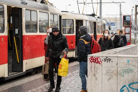 People waiting walking the platform while waiting descending for tram on a sn Stock Photos