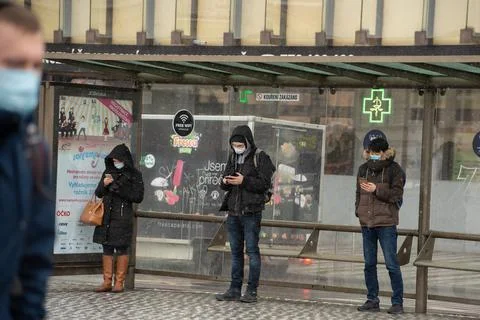 People waiting walking the platform while waiting descending for tram on a sn Stock Photos