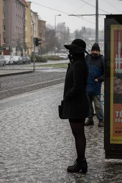 People waiting walking the platform while waiting descending for tram on a sn Stock Photos