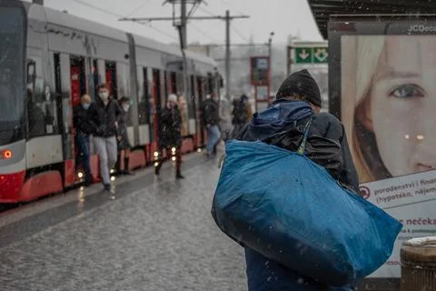 People waiting walking the platform while waiting descending for tram on a sn Stock Photos