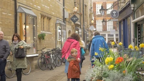 People walk along the charming old street in the center of Cambridge Stock Footage 104792453