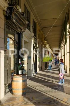 People walk along famous arcade on Rivoli street, Paris, France Stock Photos
