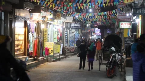 People walk along a lighted street Stock Footage 59182362