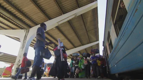 People Walk Along Side Of A Train In A Station.DaresSalaam Tanzania Stock Footage 132000168