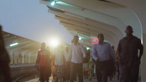 People Walk Along Side Of A Train In A Station.DaresSalaam Tanzania Stock Footage 132483008