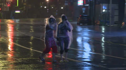 People Walk Along Street In Hurricane Stock Footage