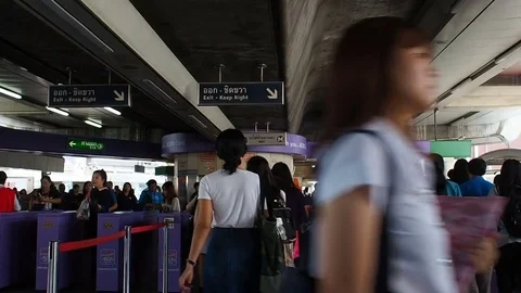 People walk in and exit gates at BTS Skytrain, Bangkok, Thailand Stock Footage 82741307