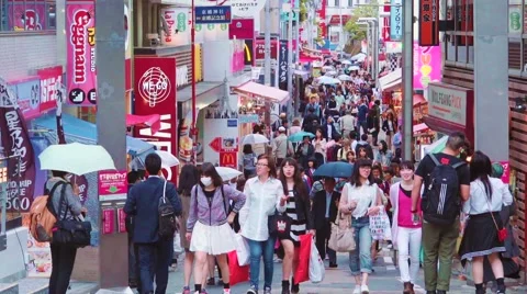  People walk and shop along Takeshita Street in Harajuku, Tokyo, Japan Stock Footage