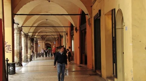 People walk by the arcade at Piazza Santo Stefano in Bologna, Italy. Stock Footage 59792786