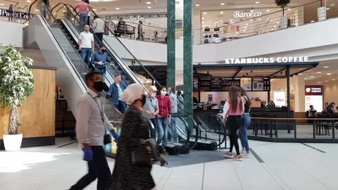 People walk around the mall wearing masks on their faces Stock Footage